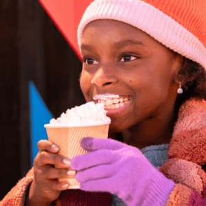 girl drinking hot chocolate with whipped cream in the winter time